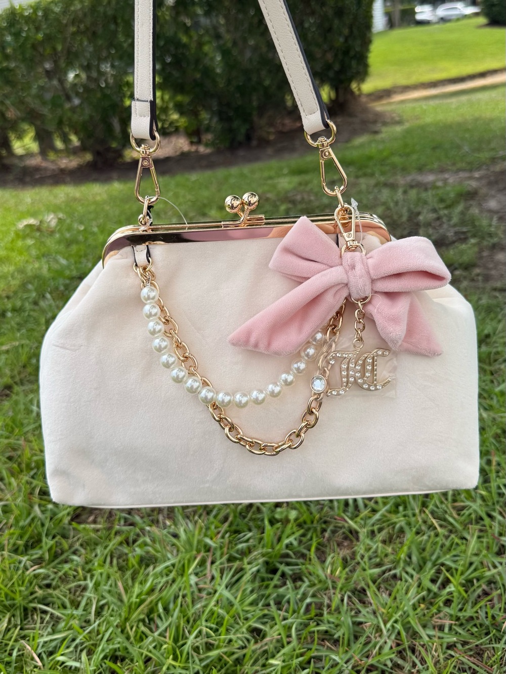 Juicy couture Elegant Cream Frame Satchel with Pink Bow Accent